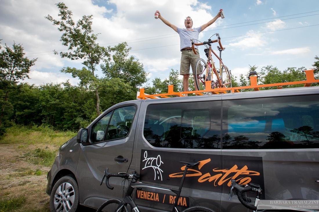 Cyclist and bike on top of a van